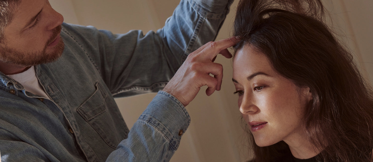 Jay inspects hair and scalp of a woman