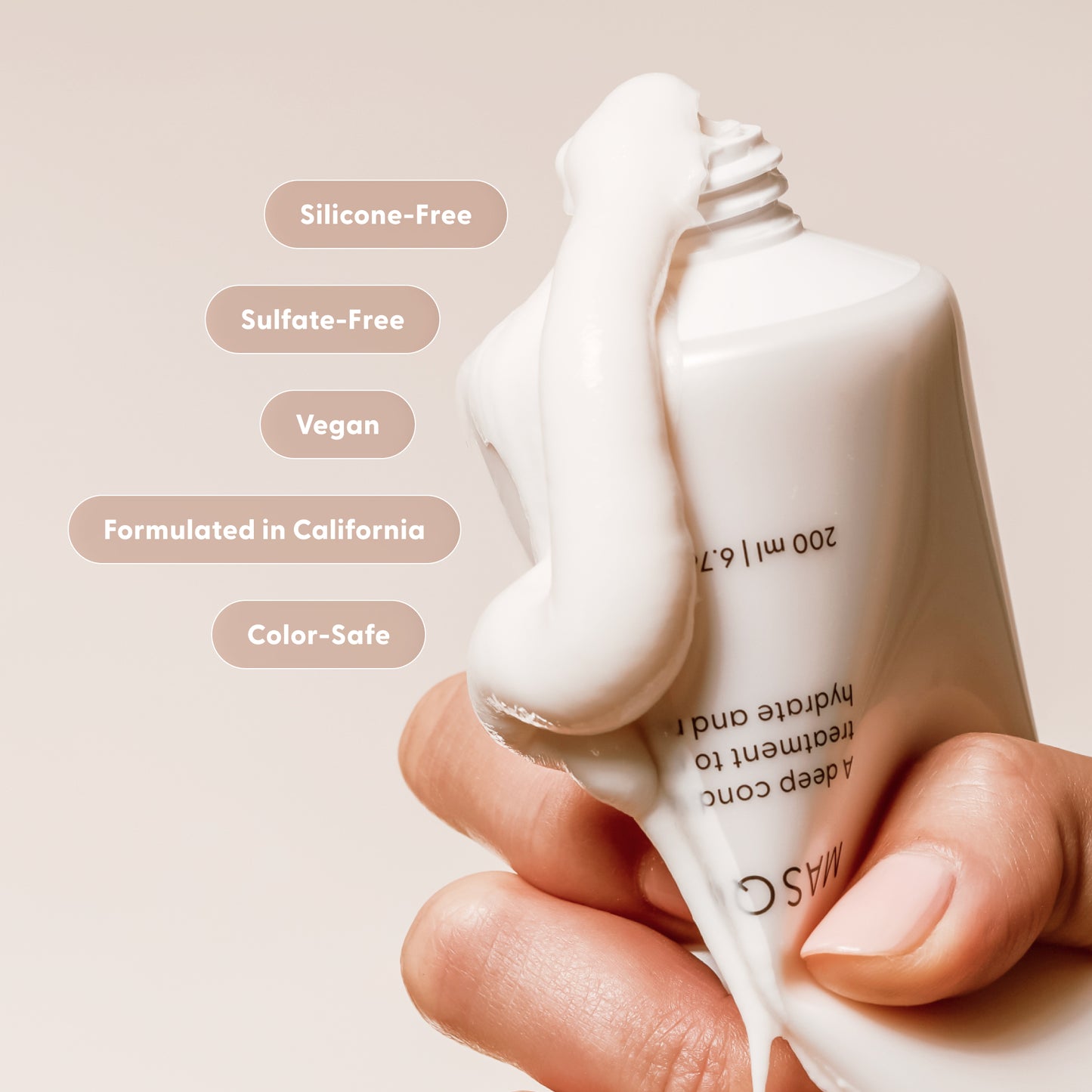 Hand holding a bottle of masque deep conditioner product with text highlighting features on a beige background