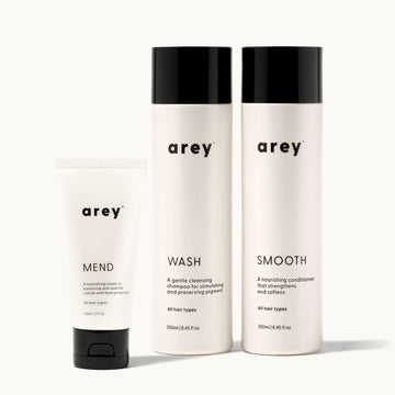 Three 'arey' hair care products, Mend, Wash, and Smooth, on a white background