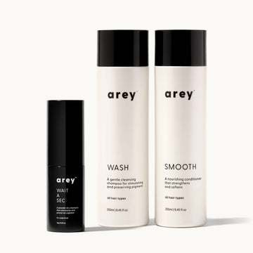 Set of arey hair care products including 'Wait a sec', 'Wash', and 'Smooth' on a white background