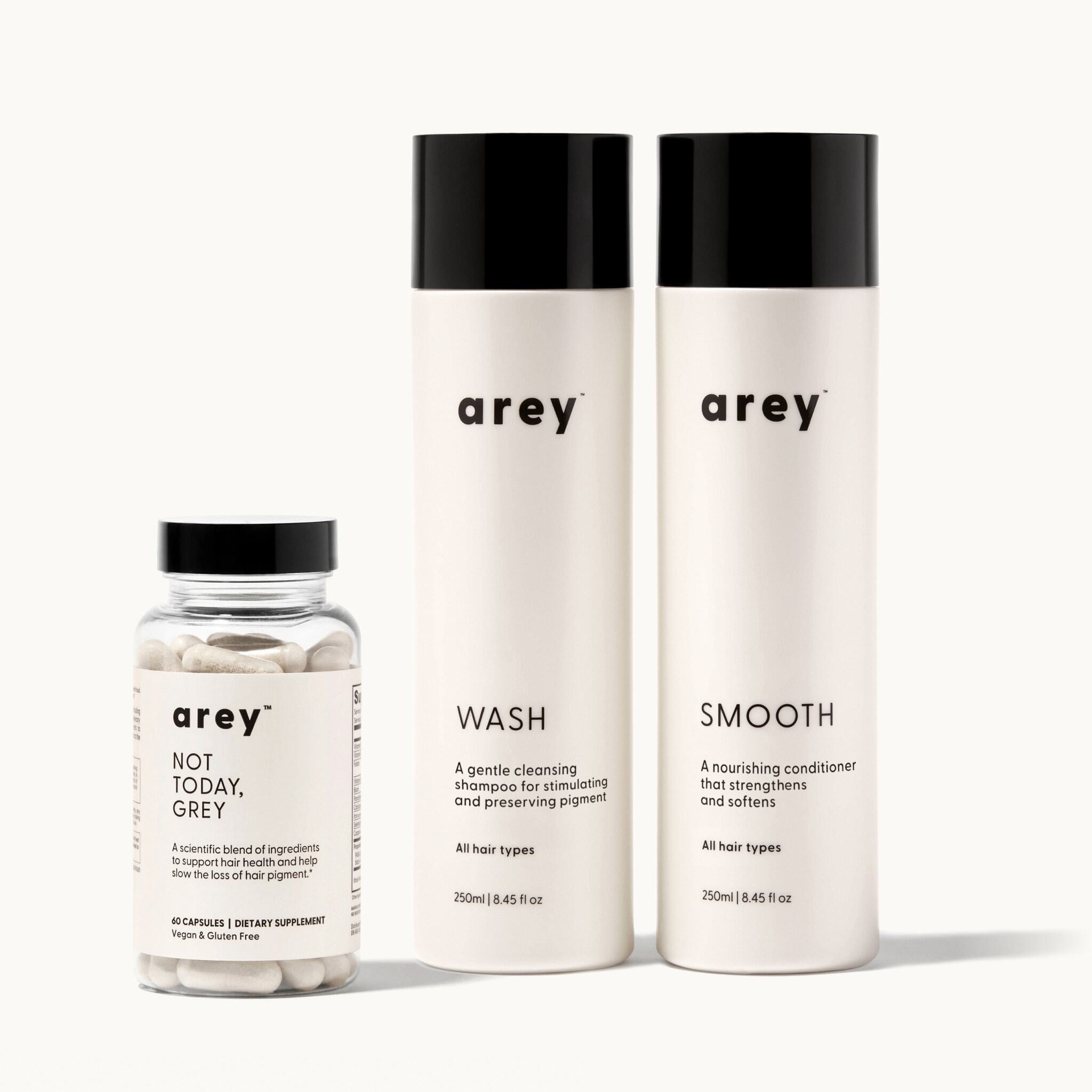 Set of arey hair care products including a bottle of Not Today Grey, and two bottles, Wash Shampoo and Smooth Conditioner