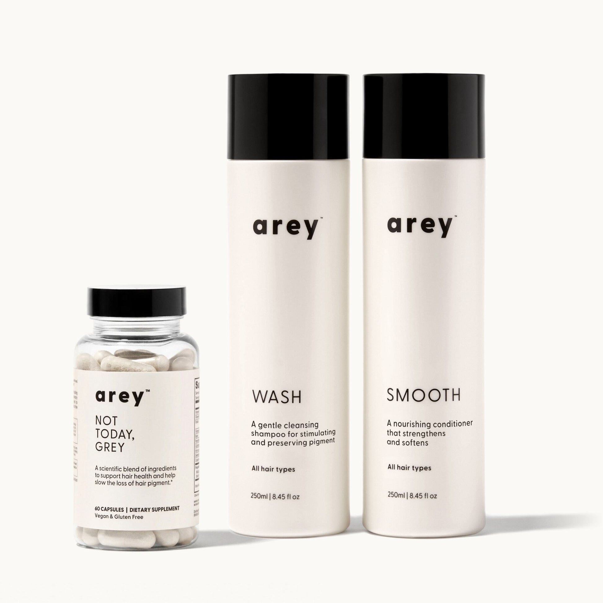 Set of arey hair care products including a bottle of Not Today Grey, and two bottles, Wash Shampoo and Smooth Conditioner