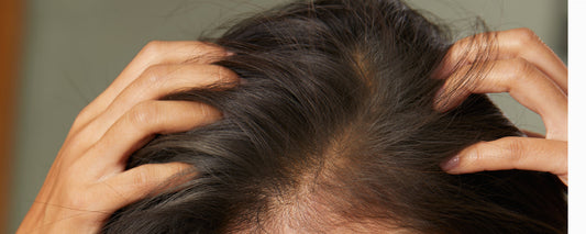 Woman checks hair for endocrine disruptor damage
