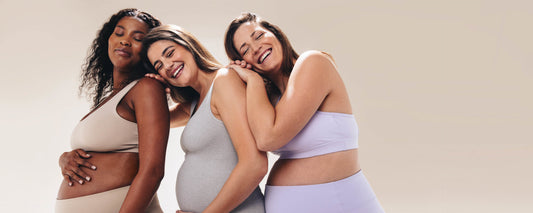 Three pregnant women hugging
