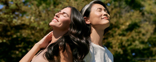 2 women with beautiful hair enjoy the sun while protecting their hair and scalp from sun damage