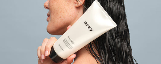 girl holding Masque bottle