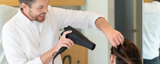 Arey Trichologist Jay Small consults with female client on hair health  