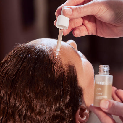 Image of Calm It Down being applied to someone's scalp