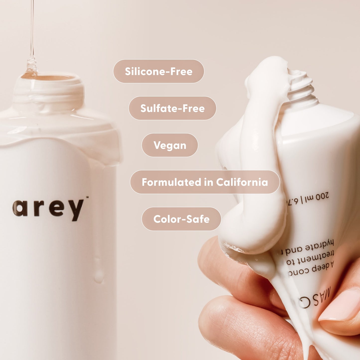 A minimal, neutral-toned scene shows a hand squeezing white cream from a tube beside a bottle labeled Arey—both part of The Deep Treatment Duo, designed to delay greys. Highlighted text notes the duo is silicone-free, sulfate-free, vegan, color-safe, and formulated in California.