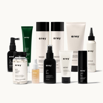 Lineup product photo of the complete Arey hair care collection including Good Night Grey, To The Root, Not Today Grey, Calm It Down, Wash, Smooth, Live In Mist, Mend, Wait A Sec, Masque, and Scrub on a white background