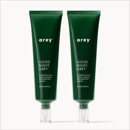 Product shot of two arey Good Night, Grey scalp serum tubes (100 ml | 3.38 fl oz each) on a white background. Label reads: arey® GOOD NIGHT, GREY. "A nighttime scalp serum to support hair health and pigment."