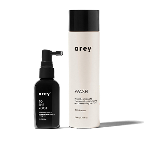Two bottles of 'arey' hair care products on a white background