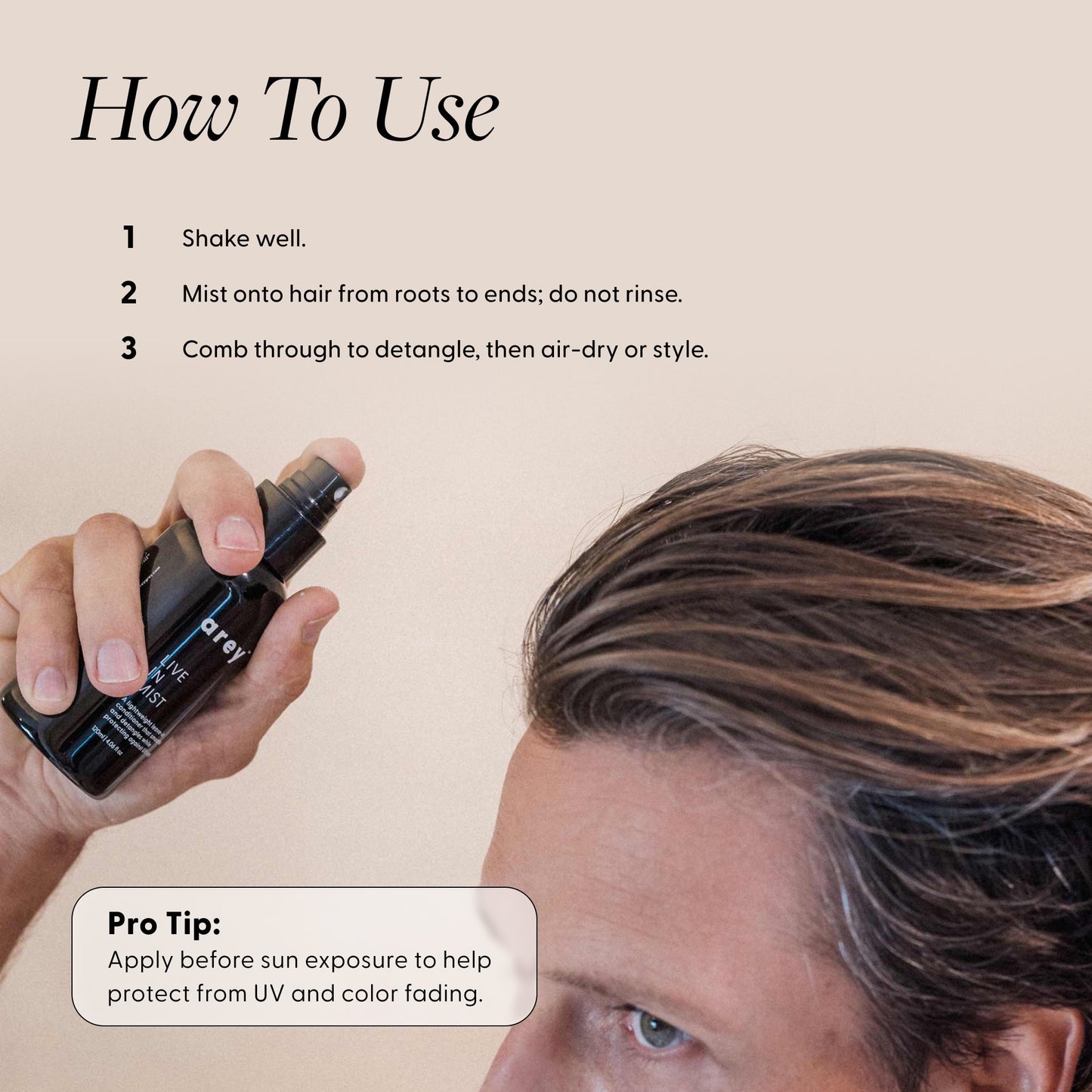 Person holding a hair product spray with usage instructions on a beige background