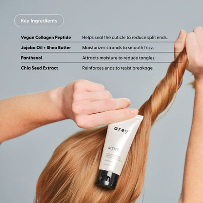 Person applying a hair care product with key ingredients listed on a gray background