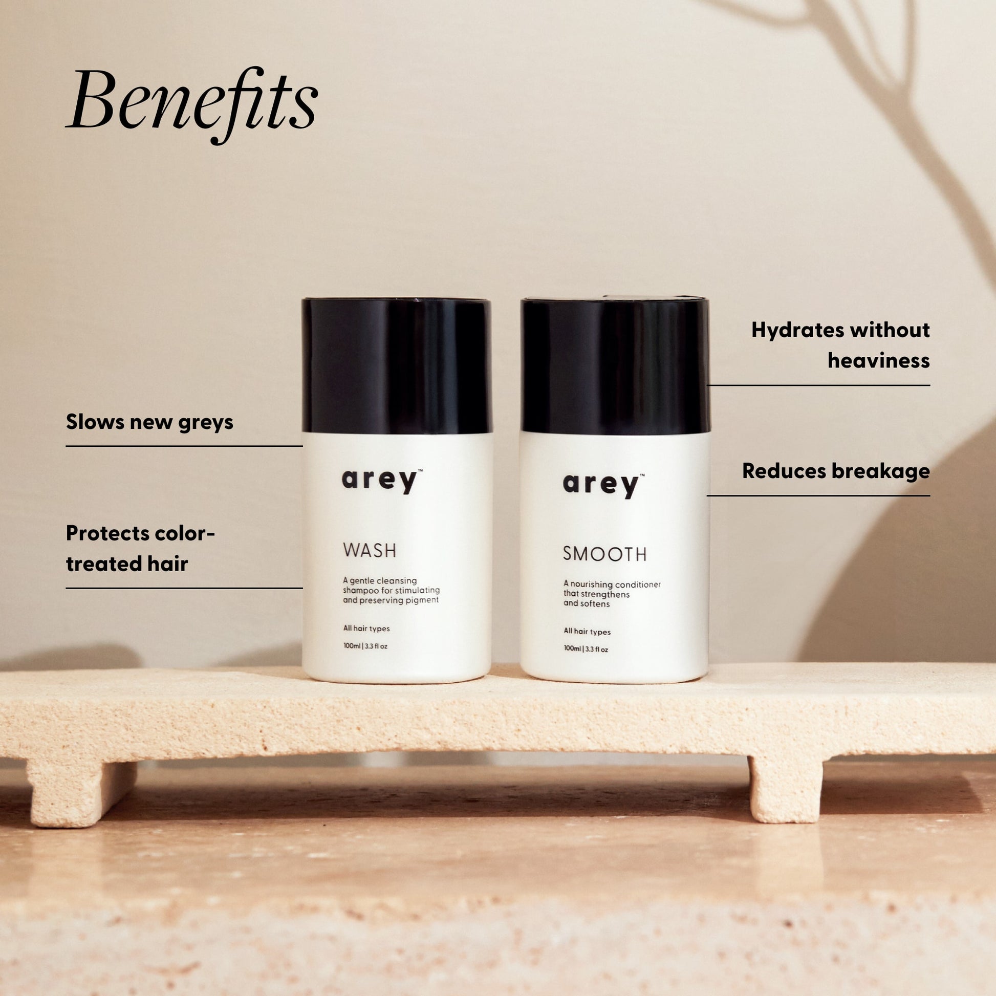 Two bottles of 'arey' hair care products on a platform with text highlighting benefits.