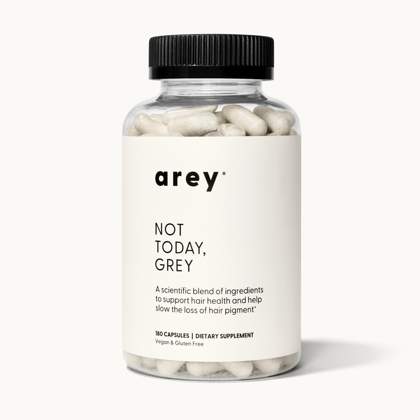 Product shot of the Arey Not Today Grey 3-month supply bottle on a white/cream background. Label reads: arey® Not Today, Grey. "A scientific blend of ingredients to support hair health and help slow the loss of hair pigment.†" 180 Capsules, Dietary Supplement, Vegan & Gluten Free.
