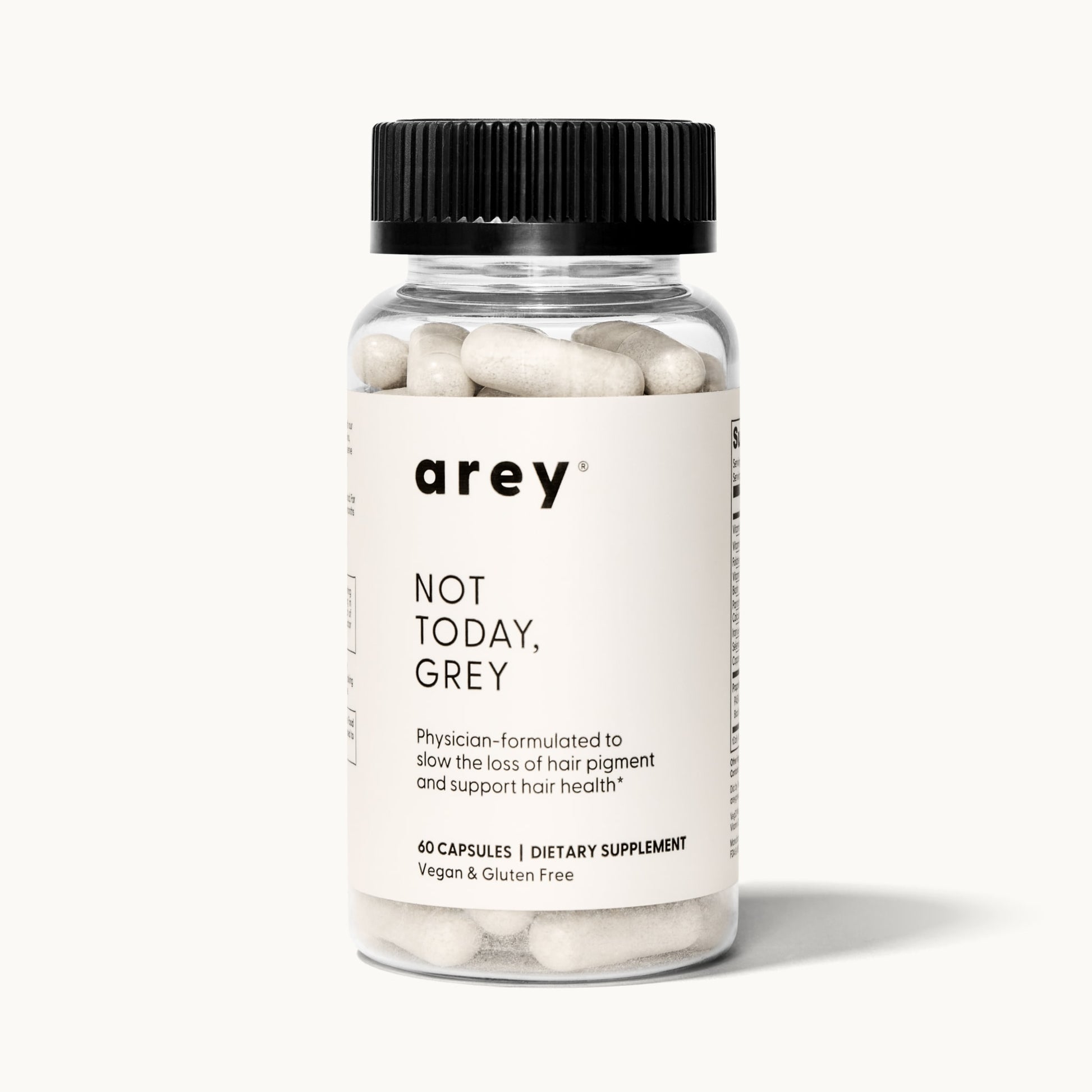 Product shot of a single Arey Not Today Grey supplement bottle on a white/cream background. Label reads: arey® Not Today, Grey. "Physician-formulated to slow the loss of hair pigment and support hair health.†" 60 Capsules, Dietary Supplement, Vegan & Gluten Free.