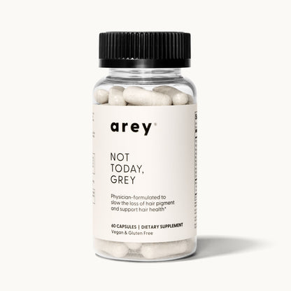 Product shot of a single Arey Not Today Grey supplement bottle on a white/cream background. Label reads: arey® Not Today, Grey. "Physician-formulated to slow the loss of hair pigment and support hair health.†" 60 Capsules, Dietary Supplement, Vegan & Gluten Free.
