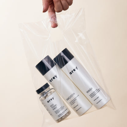 Lifestyle imagery of Wash, Smooth, and Not Today, Grey in a clear plastic bag