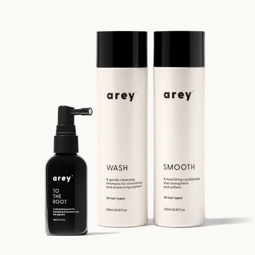 Set of arey hair care products including a to the root, wash, and smooth conditioner on a white background.