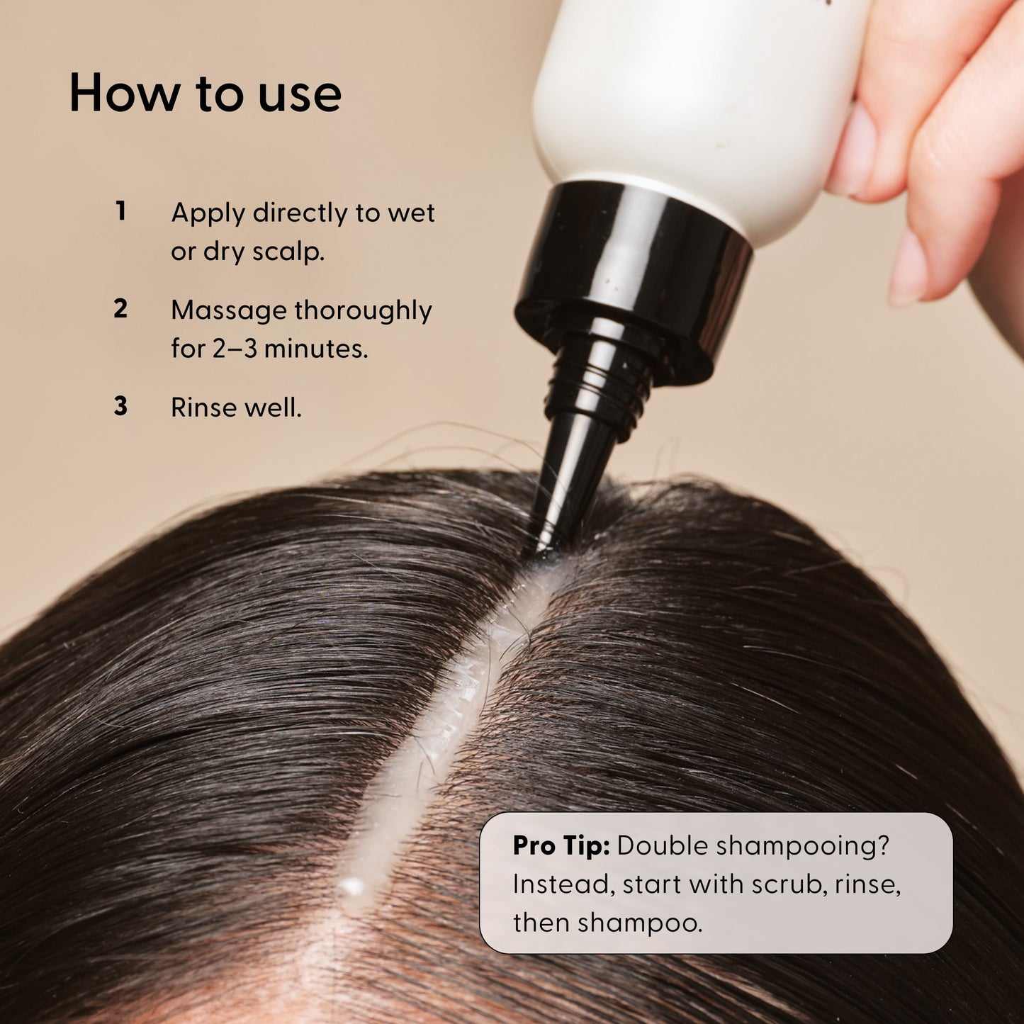A close-up of a person’s scalp as Arey’s Scrub Scalp Exfoliant is applied along the hair parting. Instructional text explains how to use the product, along with a pro tip on scalp care before shampooing.