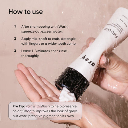 A person’s wet hands hold a bottle labeled Arey Smooth Conditioner, squeezing out the white, nourishing formula. The text offers usage instructions and a pro tip to pair Smooth Conditioner with Arey Wash for optimal color preservation.