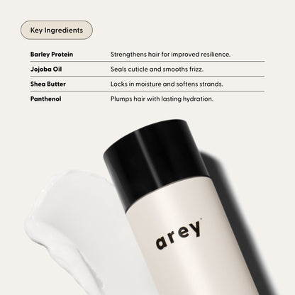 Hair care product with key ingredients listed on a white background
