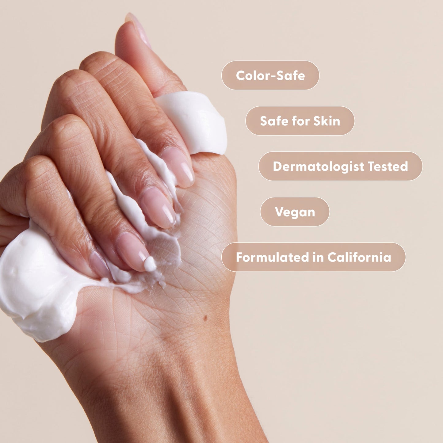 A hand squeezes Arey’s Smooth Conditioner Refill—white cream flows out, surrounded by text bubbles: Color-Safe, Safe for Skin, Dermatologist Tested, Vegan, Formulated in California. This nourishing conditioner from Arey is ideal for hair repair—all on a neutral beige background.