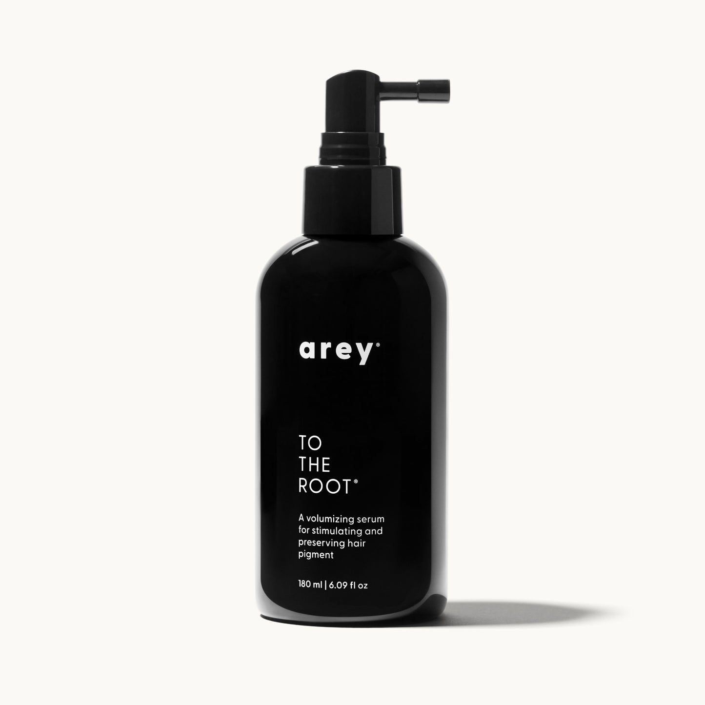 Single Arey To The Root serum bottle on a cream background, representing a 3-month supply. Bottle labeled: arey. TO THE ROOT. A volumizing serum for stimulating and preserving hair pigment. 180 ml / 6.09 fl oz.