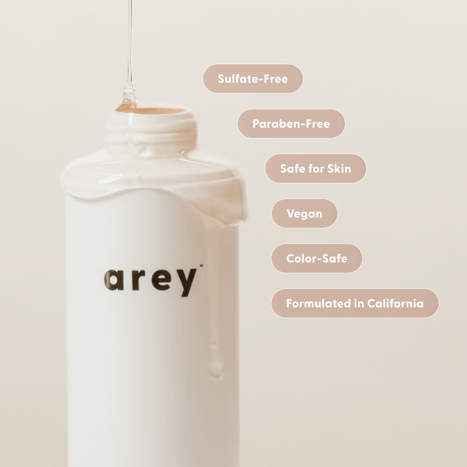 White bottle with 'Arey' branding on a light beige background with product features listed.