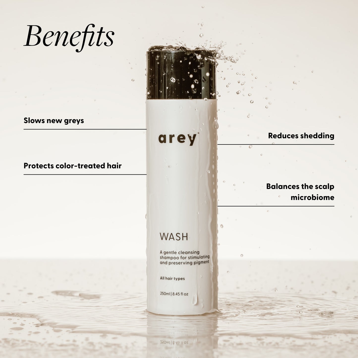 Shampoo bottle labeled 'arey' with benefits listed on a light background