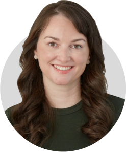 Circular headshot of a person with long brown hair wearing a green shirt.
