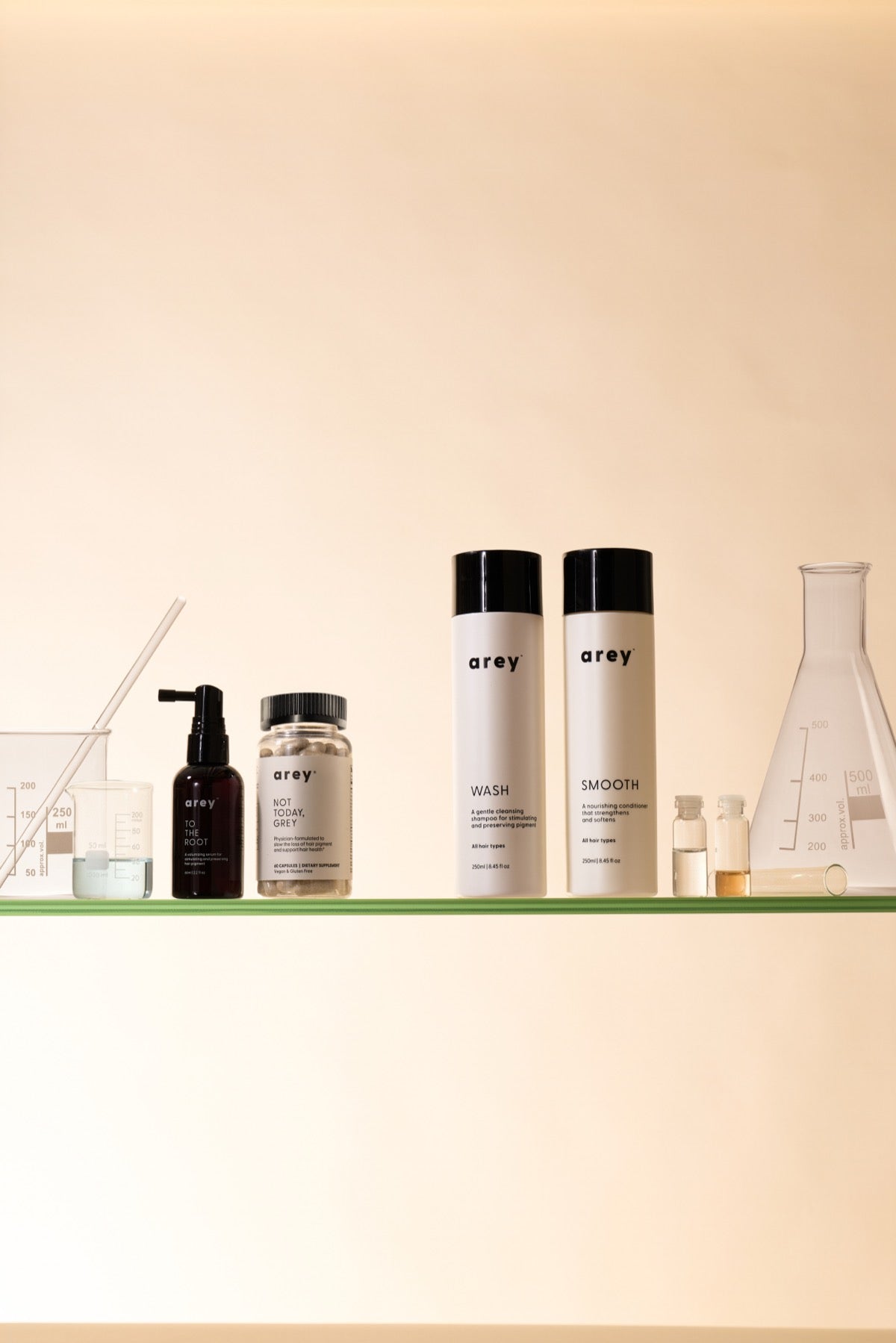 Arey products lined up on a glass shelf in a lab setting